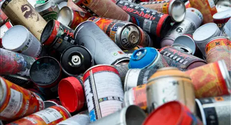 A pile of colourful areosol cans