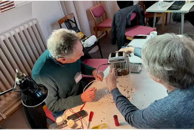 Person fixing an electrical item at a repair cafe. 