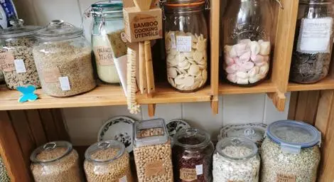 Selection of dried goods in jars and containers in a refill shop. 